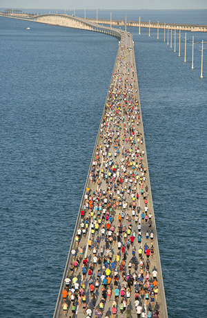A portion of the field of 1,500 competitors run across the convergence of the Atlantic Ocean and Gulf of Mexico during the Seven Mile Bridge Run. Image: Andy Newman